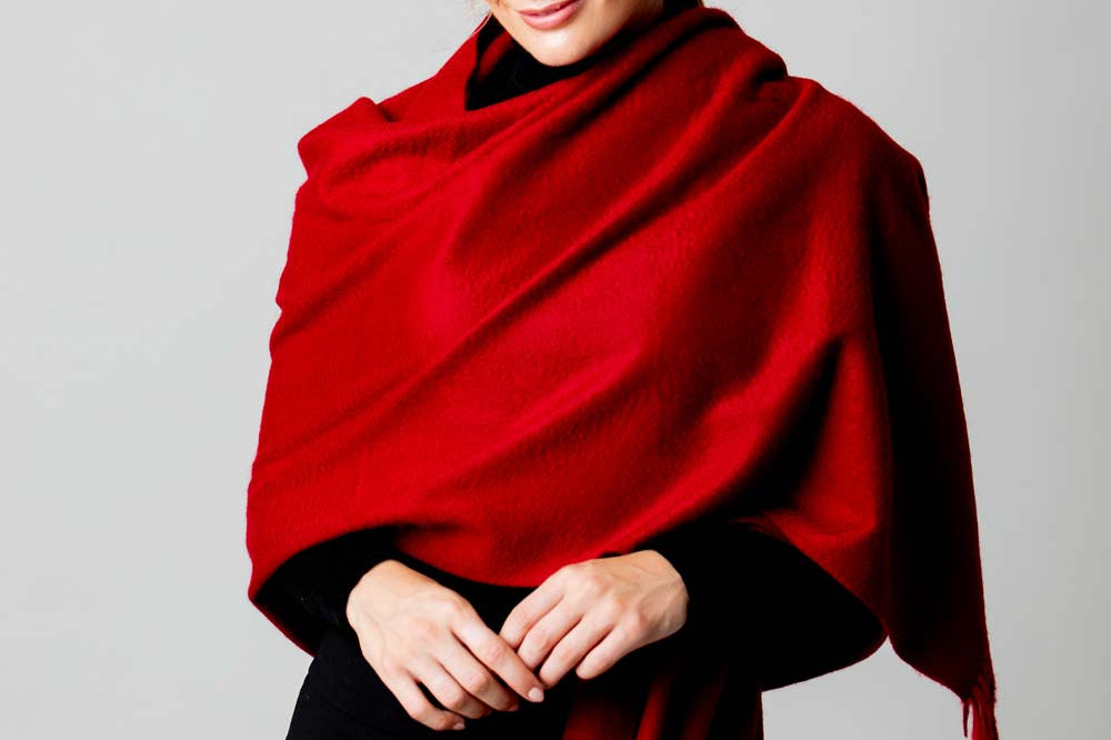 Model Wearing Alpine Cashmere Ripple Finish Wrap in Cherry Red