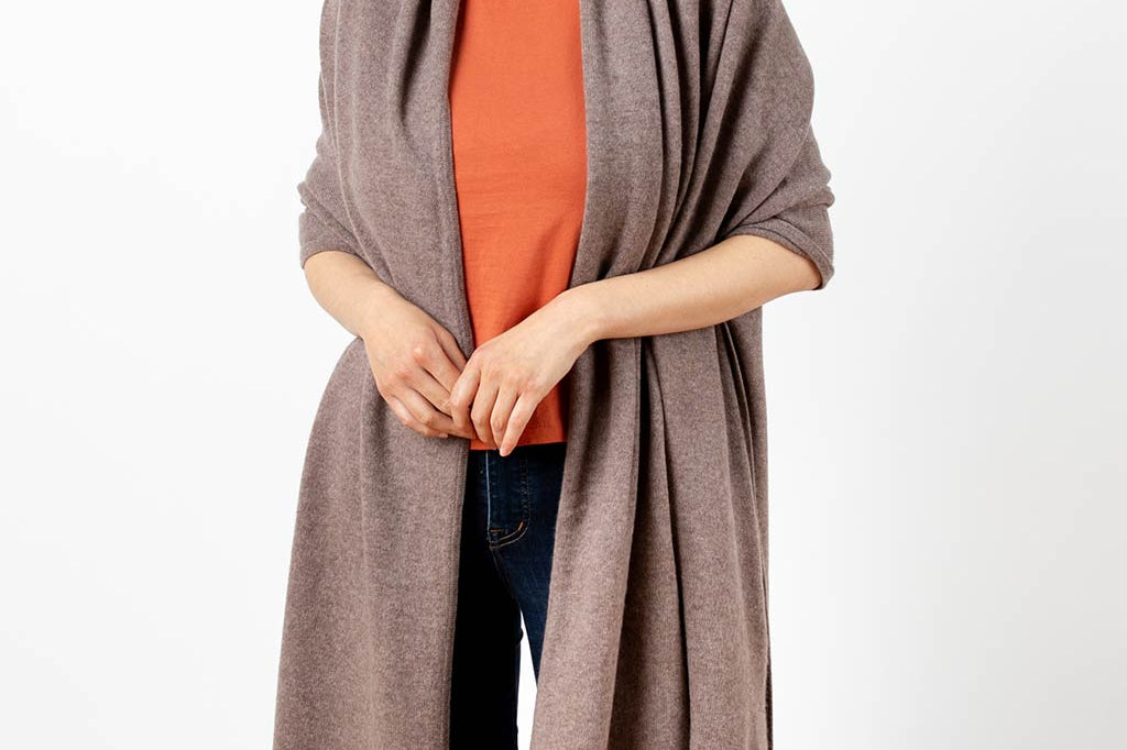 Model Wearing Alpine Cashmere's Luxurious Chunky Travel Wrap in Nutmeg Brown