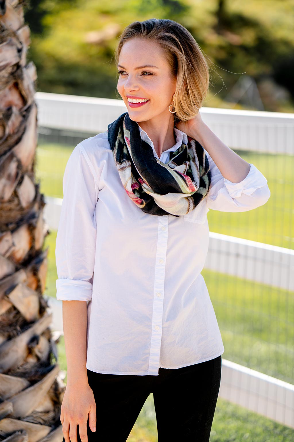 Model Wearing Alpine Cashmere's Featherweight Cinta Scarf in Black and Cranberry Red