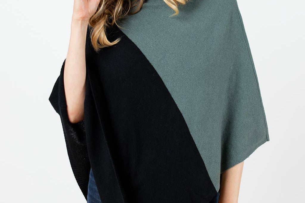 Model Wearing Alpine Cashmere Colorblock Poncho in Pine and Black