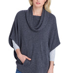 Model wearing the Alpine Cashmere Cowl Neck Poncho featuring a kangaroo pocket