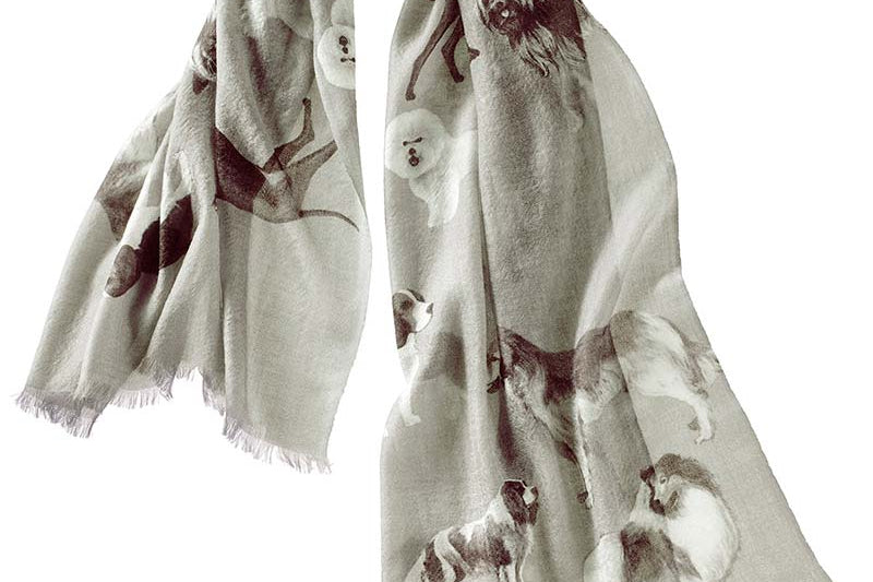 Alpine Cashmere's Dog's Life Scarf, featuring an illustrated print of dogs, in thunder gray