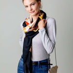 Model Wearing Alpine Cashmere's Grande Siena Scarf in Cream Made in Italy