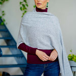 Model Wearing the Alpine Cashmere Herringbone Travel Wrap in Birch Gray and Ivory
