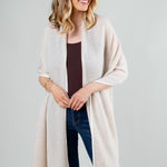 Model Wearing the Alpine Cashmere Herringbone Travel Wrap in Oatmeal and Ivory