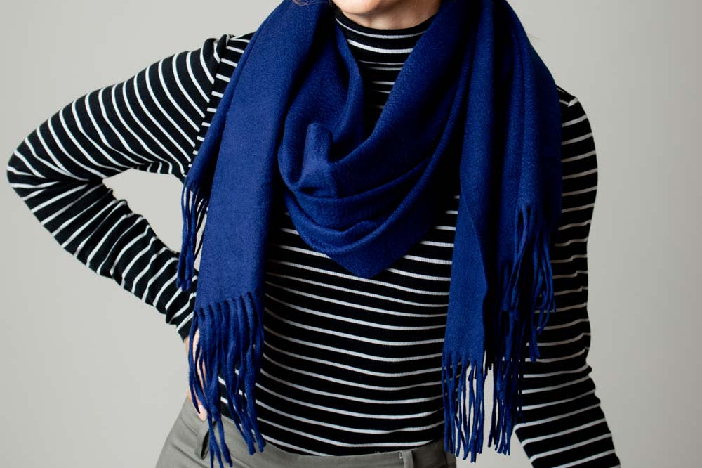 Model Wearing Alpine Cashmere Ripple Finish Wrap in Navy Blue