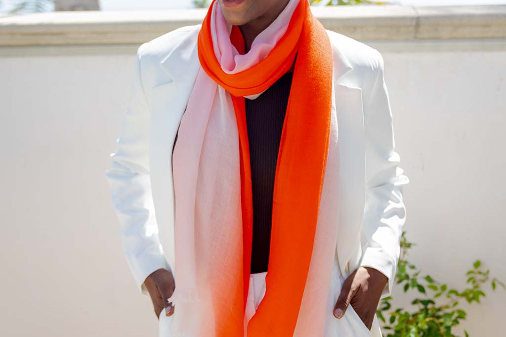 Model Wearing Alpine Cashmere Ombre Scarf in Papaya and Ecru