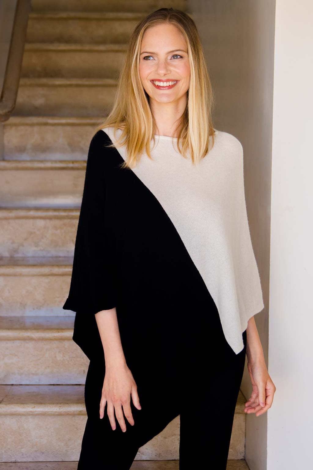 Model Wearing Alpine Cashmere Colorblock Poncho in Ivory and Black