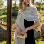 Model Wearing Alpine Cashmere Passport Travel Wrap in Flint Gray