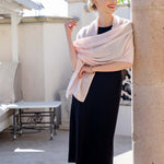 Model Wearing Alpine Cashmere Passport Travel Wrap in Seashell Pink