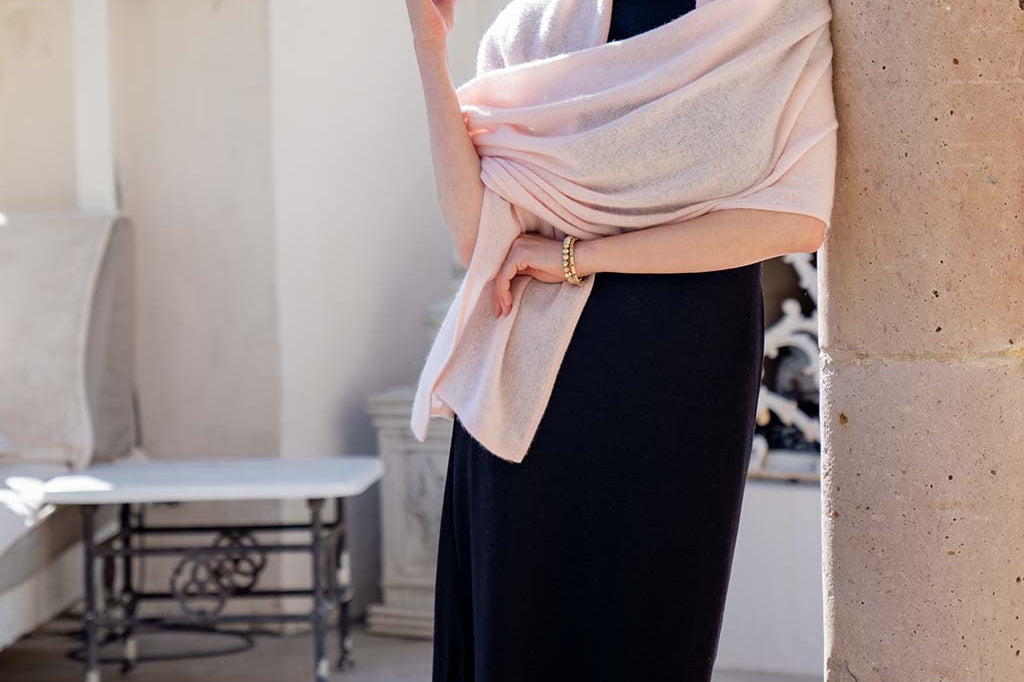Model Wearing Alpine Cashmere Passport Travel Wrap in Seashell Pink