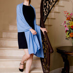 Model Wearing Alpine Cashmere Passport Travel Wrap in Wave Blue