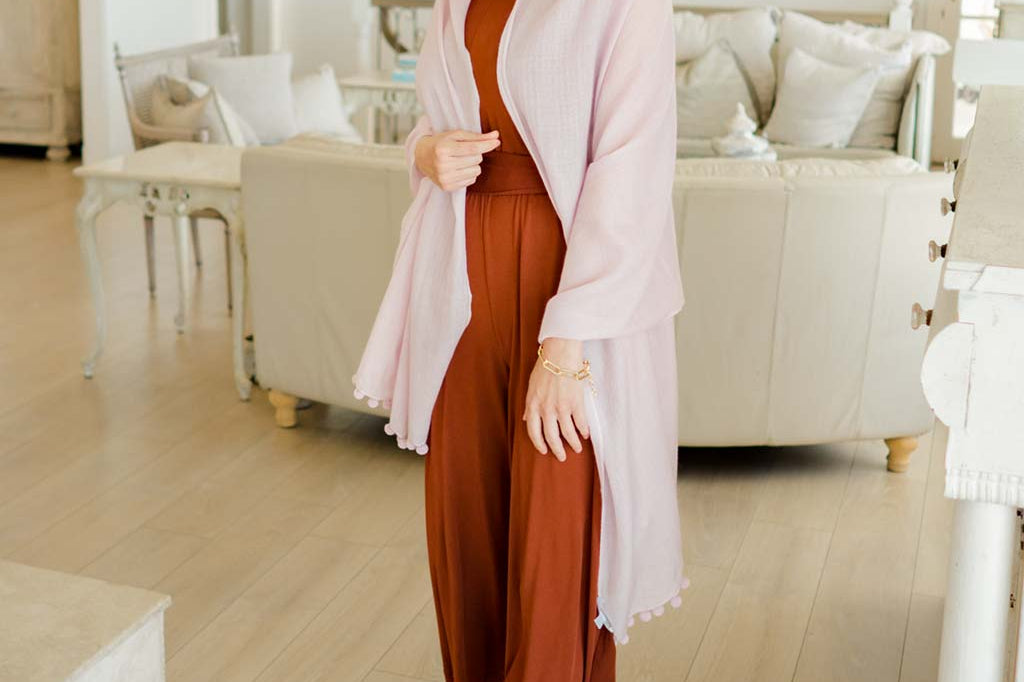Model Wearing Alpine Cashmere Pom-Pom Scarf in Parfait Pink