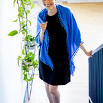 Model Wearing Alpine Cashmere Pom-Pom Triangle Wrap in Cornflower Blue