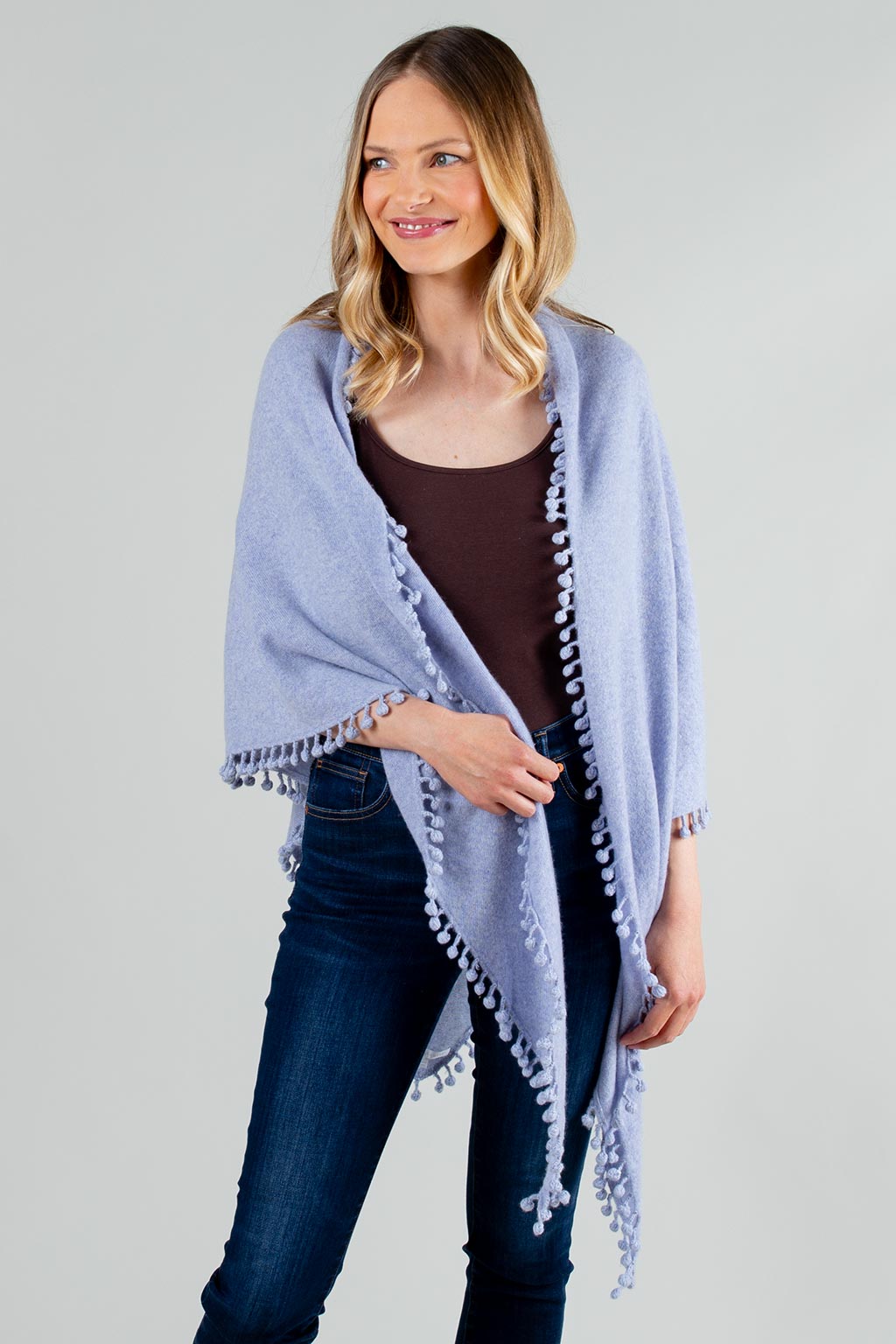 Model Wearing Alpine Cashmere Pom-Pom Triangle Wrap in Heather Purple