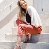 Model Wearing Alpine Cashmere Pom-Pom Triangle Wrap in Ivory
