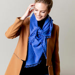 Model Wearing Alpine Cashmere Pom-Pom Triangle Wrap in Ocean Blue