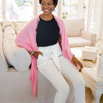 Model Wearing Alpine Cashmere Pom-Pom Triangle Wrap in Pink Mist