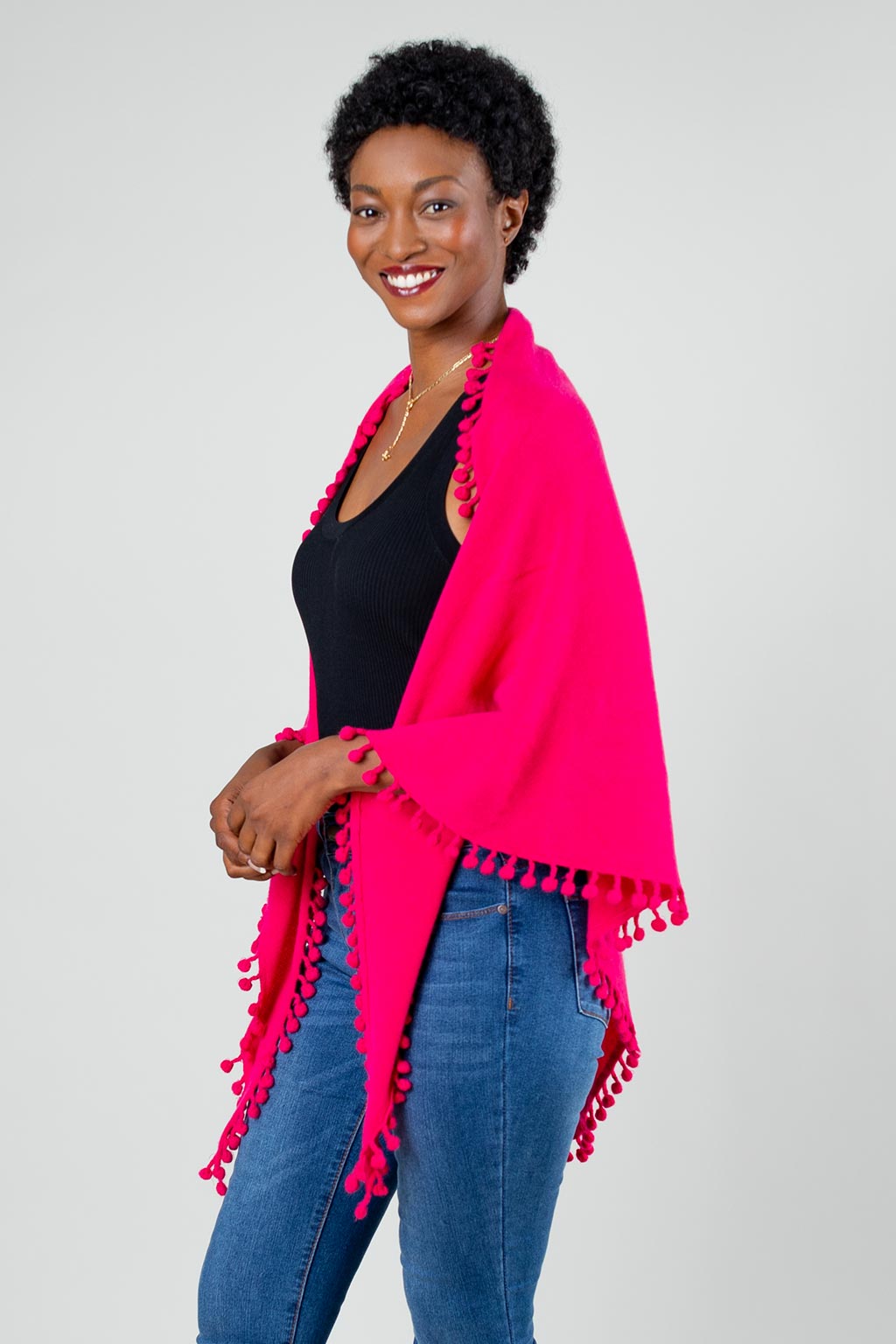 Model Wearing Alpine Cashmere Pom-Pom Triangle Wrap in Raspberry Pink