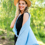 Model Wearing Alpine Cashmere Pom-Pom Triangle Wrap in Sky Blue
