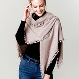 Model Wearing Alpine Cashmere Pom-Pom Triangle Wrap in Wheat