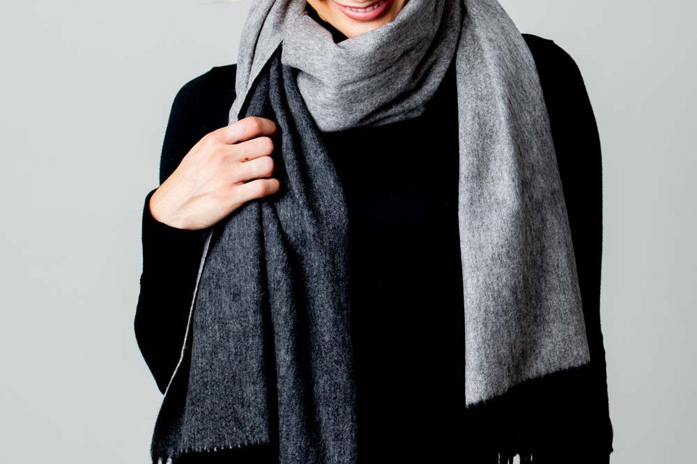 Model Wearing Alpine Cashmere Ripple Finish Reversible Wrap in Charcoal and Cinder Gray