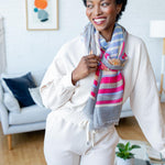 Model Wearing Alpine Cashmere Featherweight Printed Roma Scarf in Anchor Gray