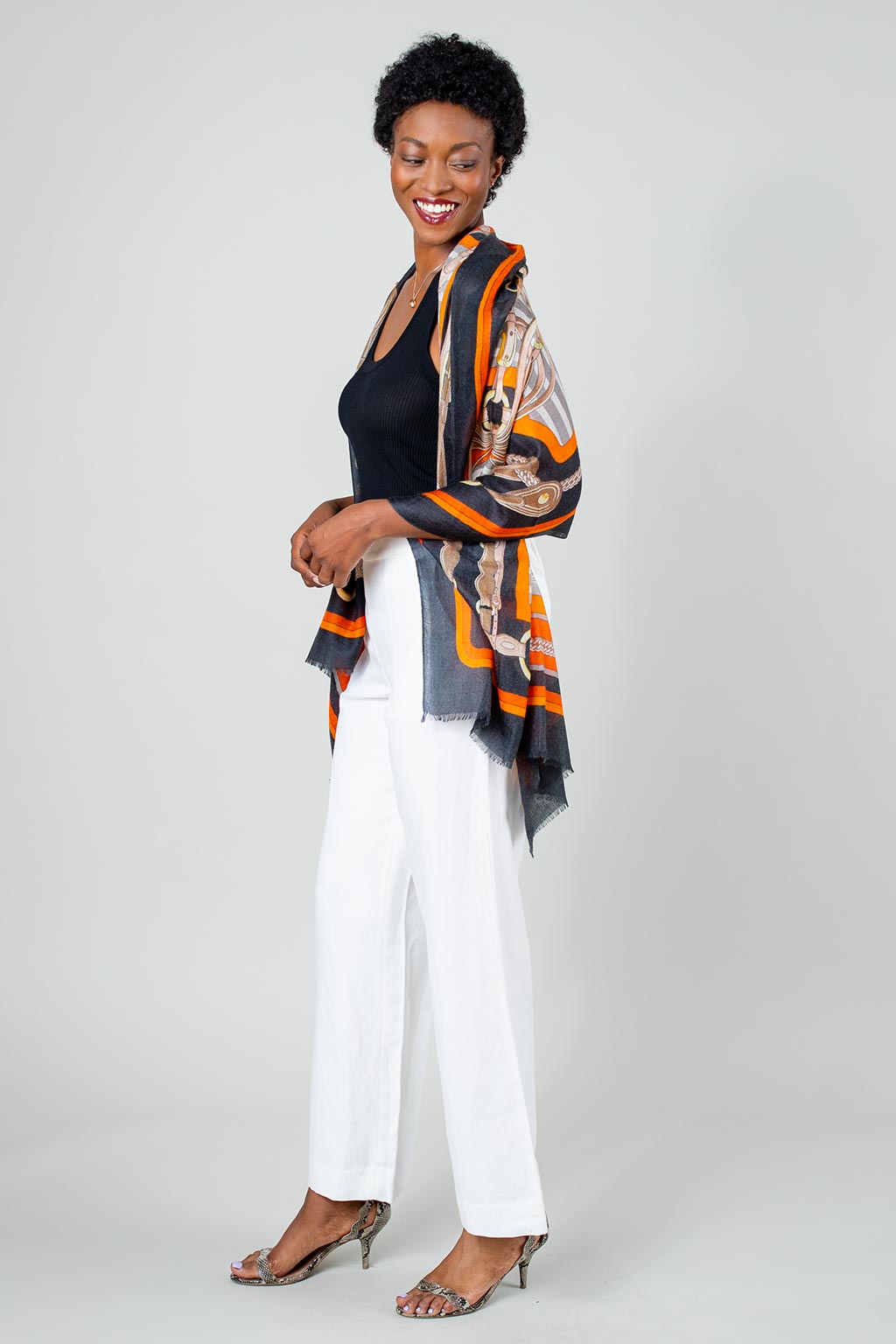Model Wearing Alpine Cashmere Featherweight Printed Roma Scarf in Mandarin Orange