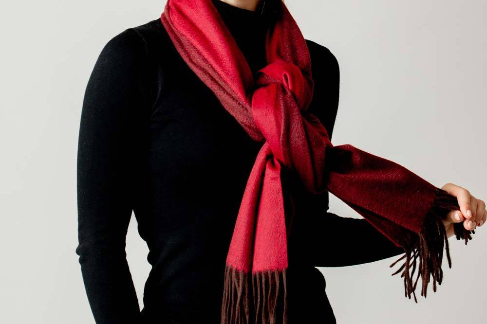 Model Wearing Alpine Cashmere Ripple Finish Reversible Wrap in Burgundy and Crimson